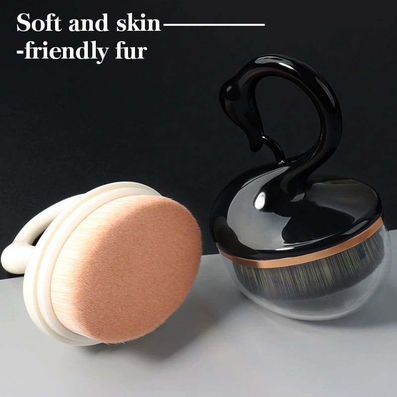 Makeup brushes, one with a swan-shaped handle and the other round with a white handle.