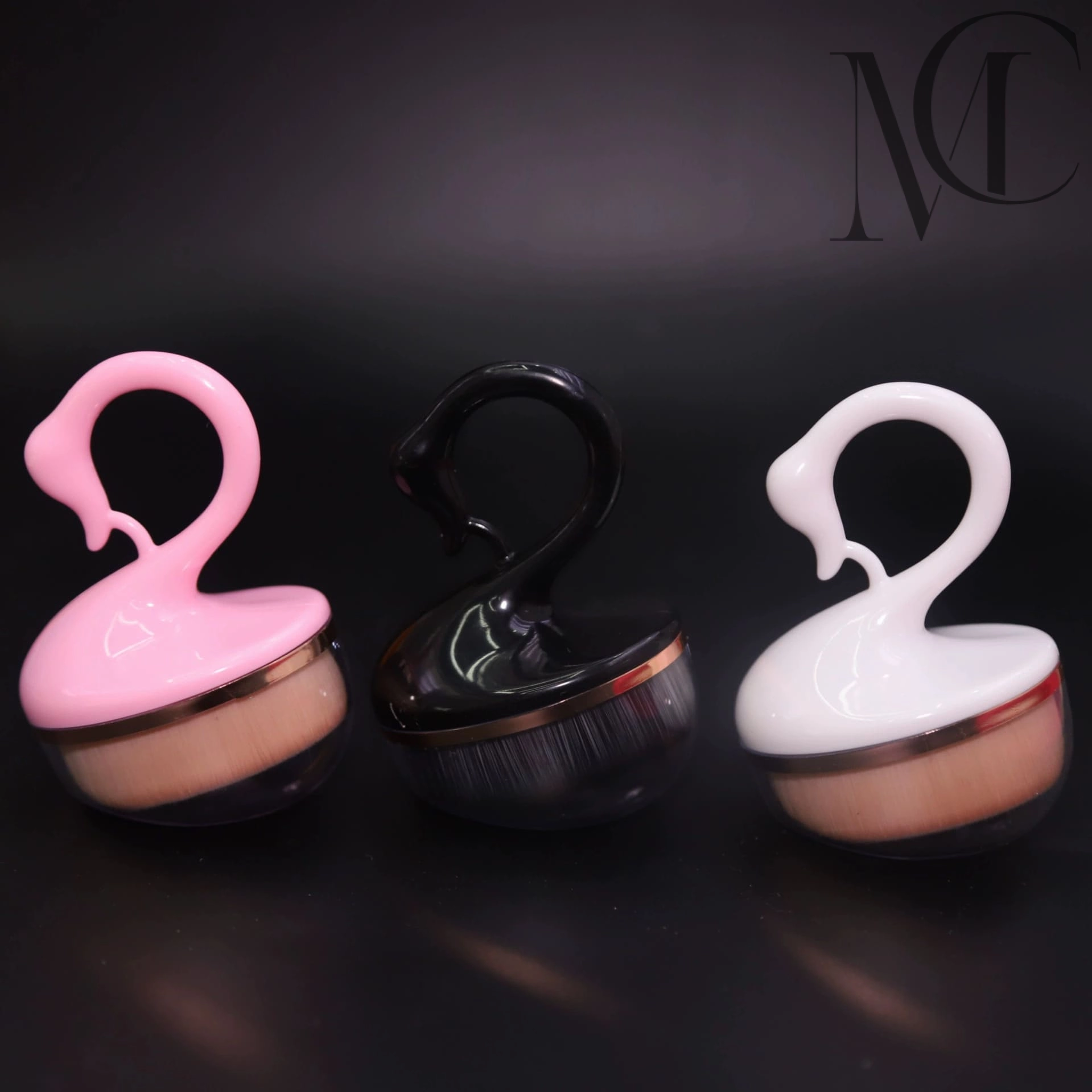 beautiful Swan Handle Body Brush Three swan-shaped makeup brushes in pink, black, and white.