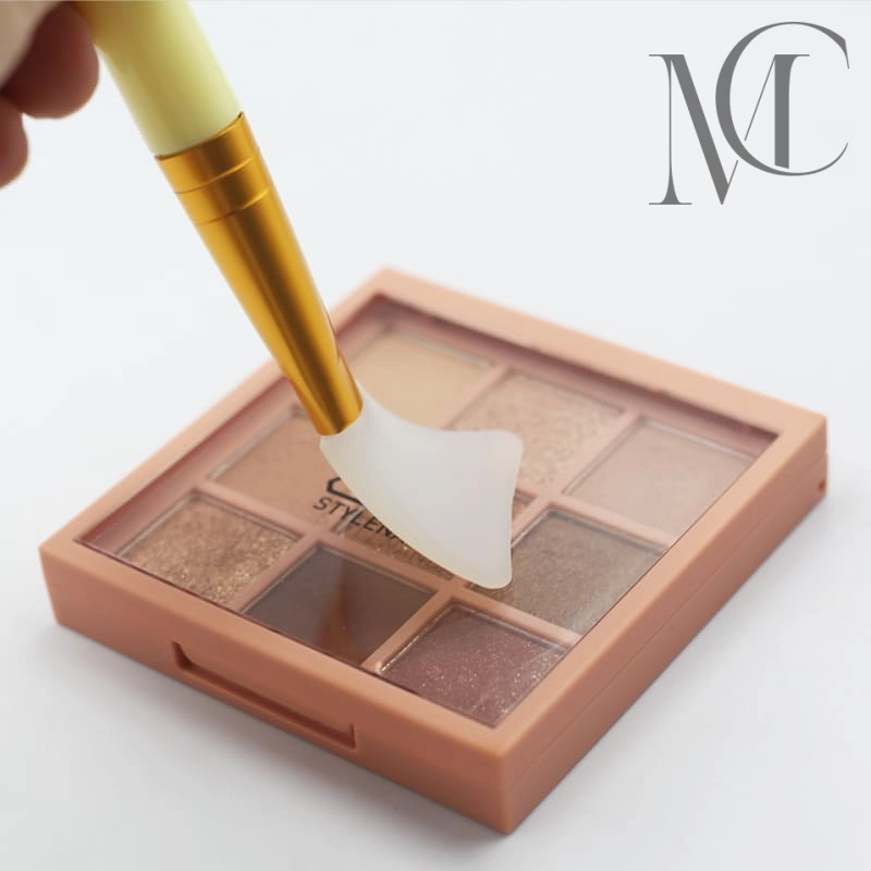 Pincel para mascarilla facial Paleta de sombras de ojos color melocotón aplicada con un pincel espátula de silicona.