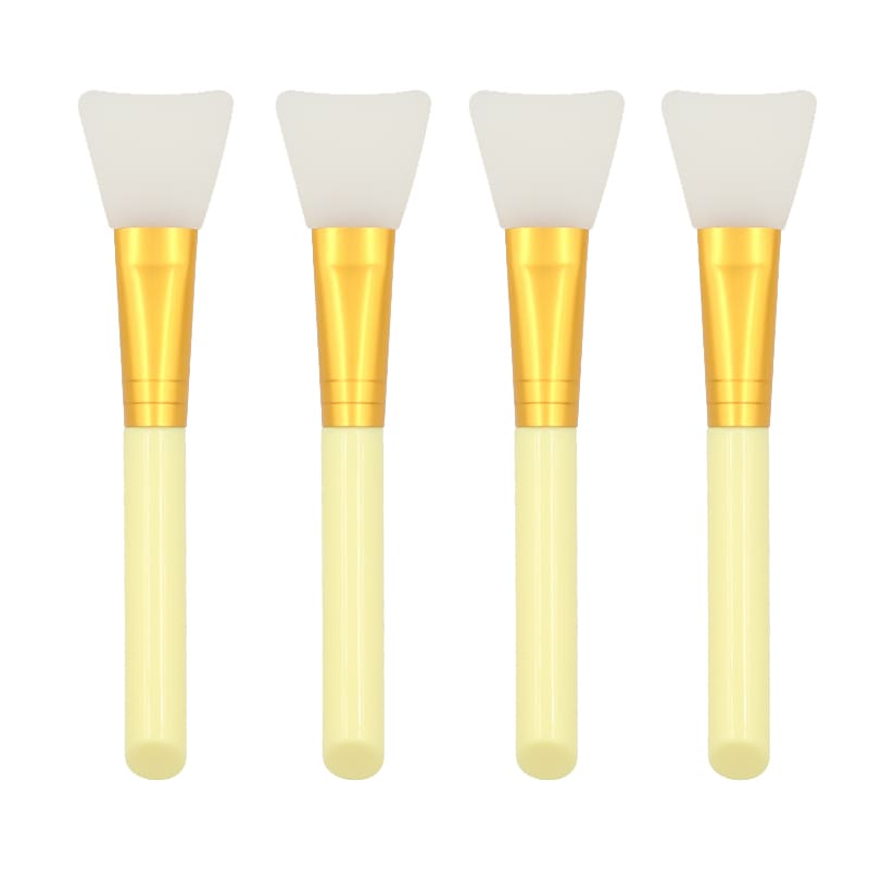Four silicone face mask applicator brushes with golden handles and cream-colored stems.