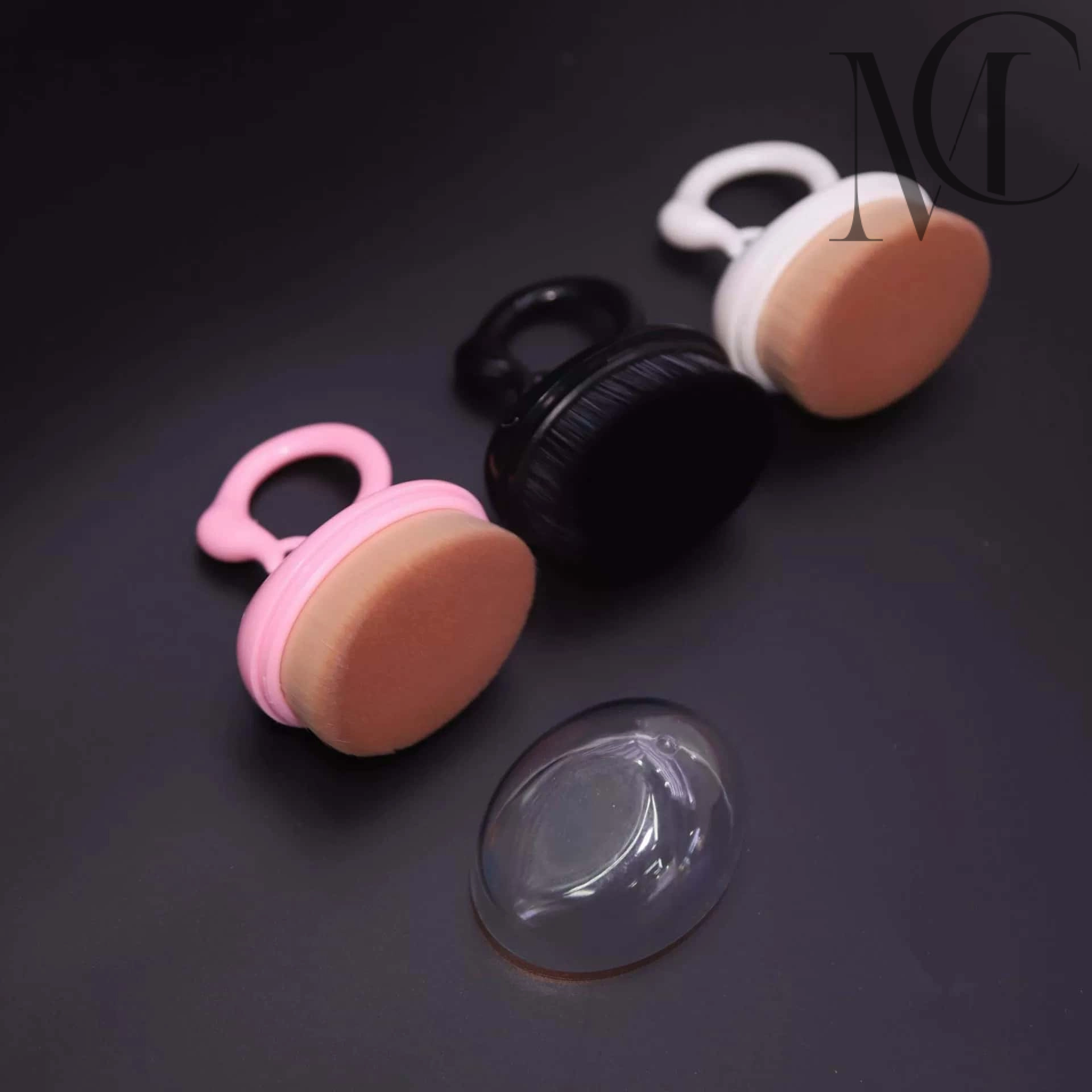 Swan Handle Body Brush manufacturer Makeup brushes with ring handles and a plastic storage cover on a black surface.