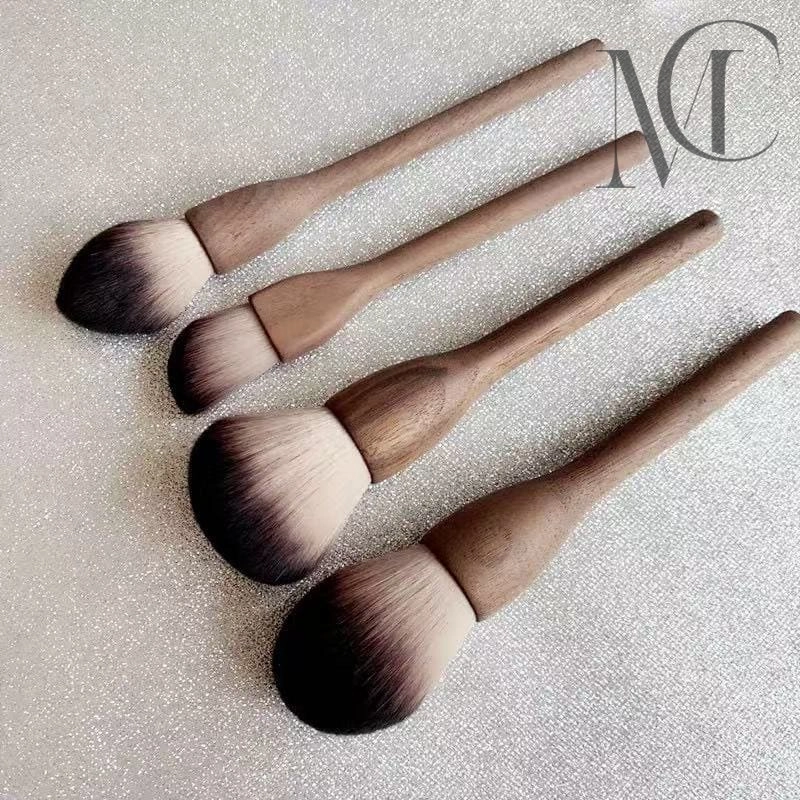 Custom wooden makeup brush Four makeup brushes with wooden handles and ombre bristles.