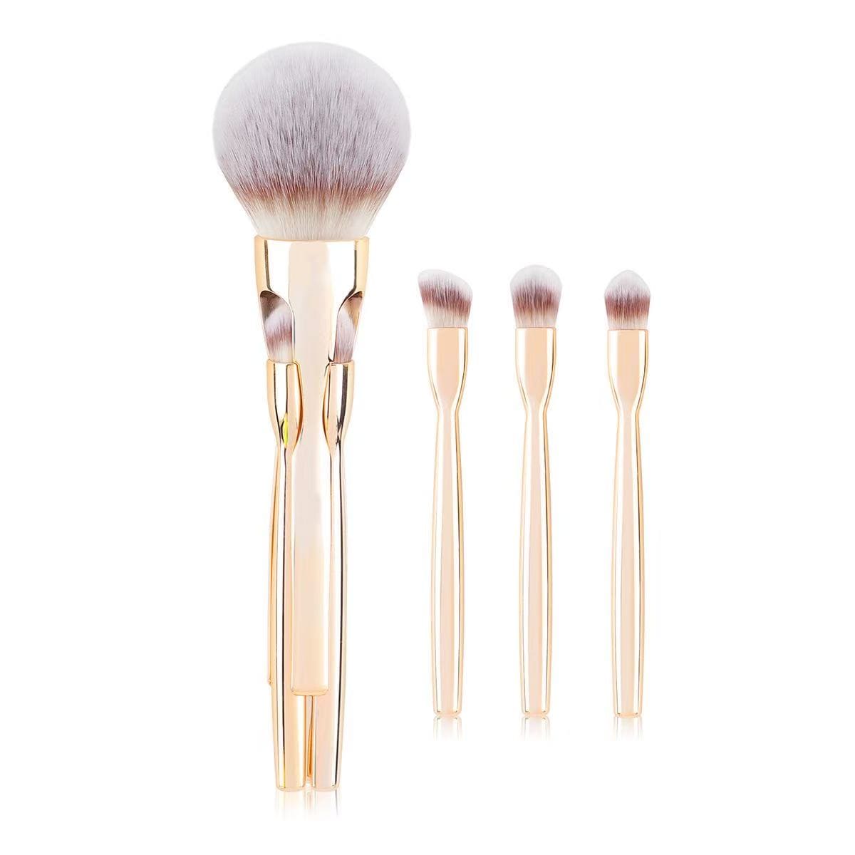 Makeup brush set with gold handles and a large powder brush.