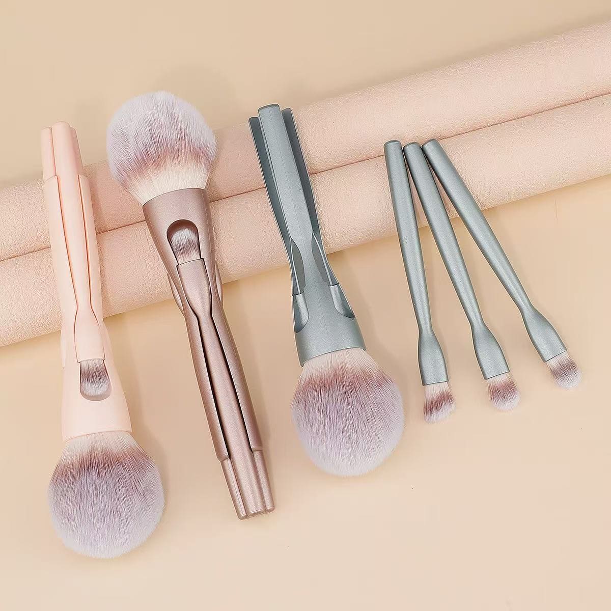 Makeup brush set with pastel colored handles.