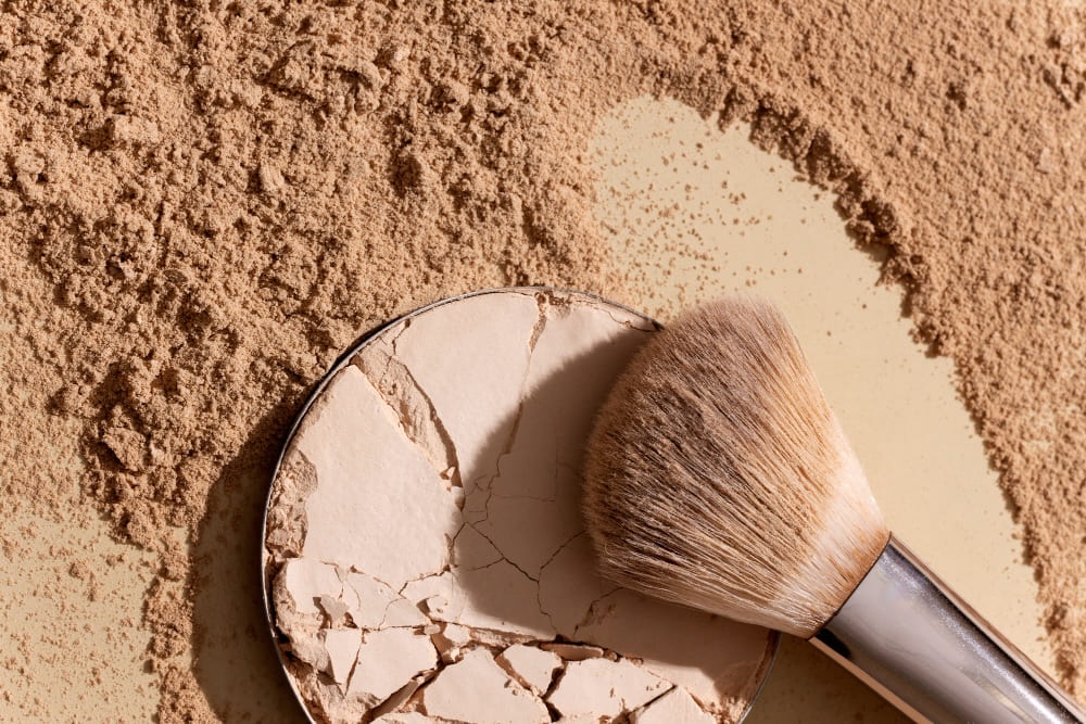 Broken face powder with brush.