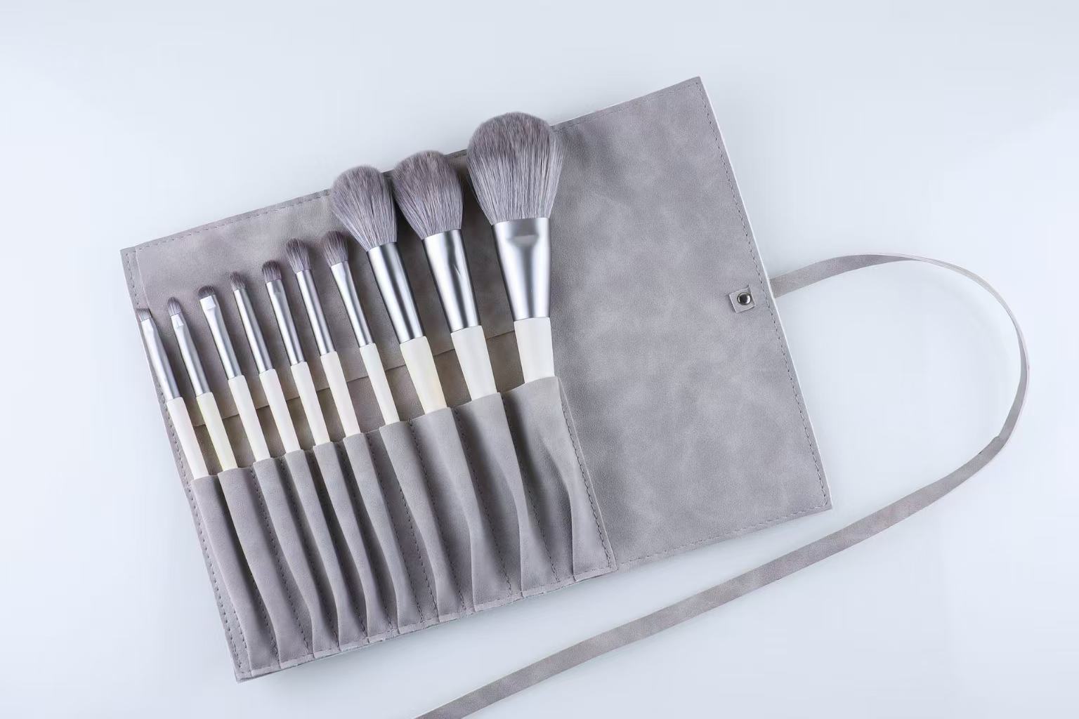 Makeup brushes in a gray holder.
