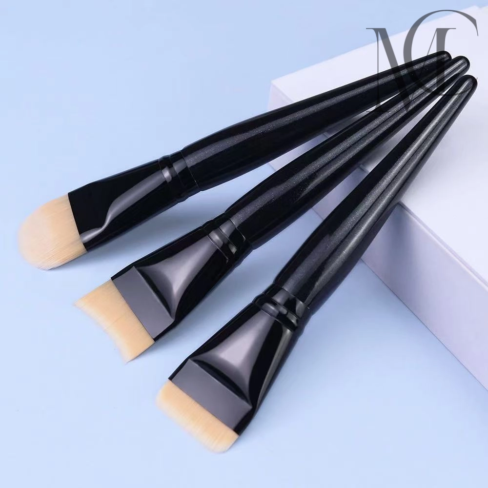 Face mask brush three-piece set Three angled foundation makeup brushes with black handles.