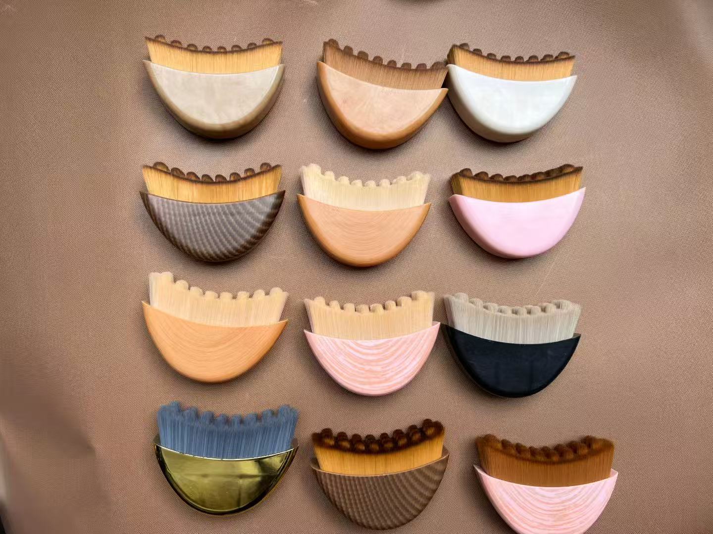 Twelve colorful, unique makeup brushes arranged on a brown surface.