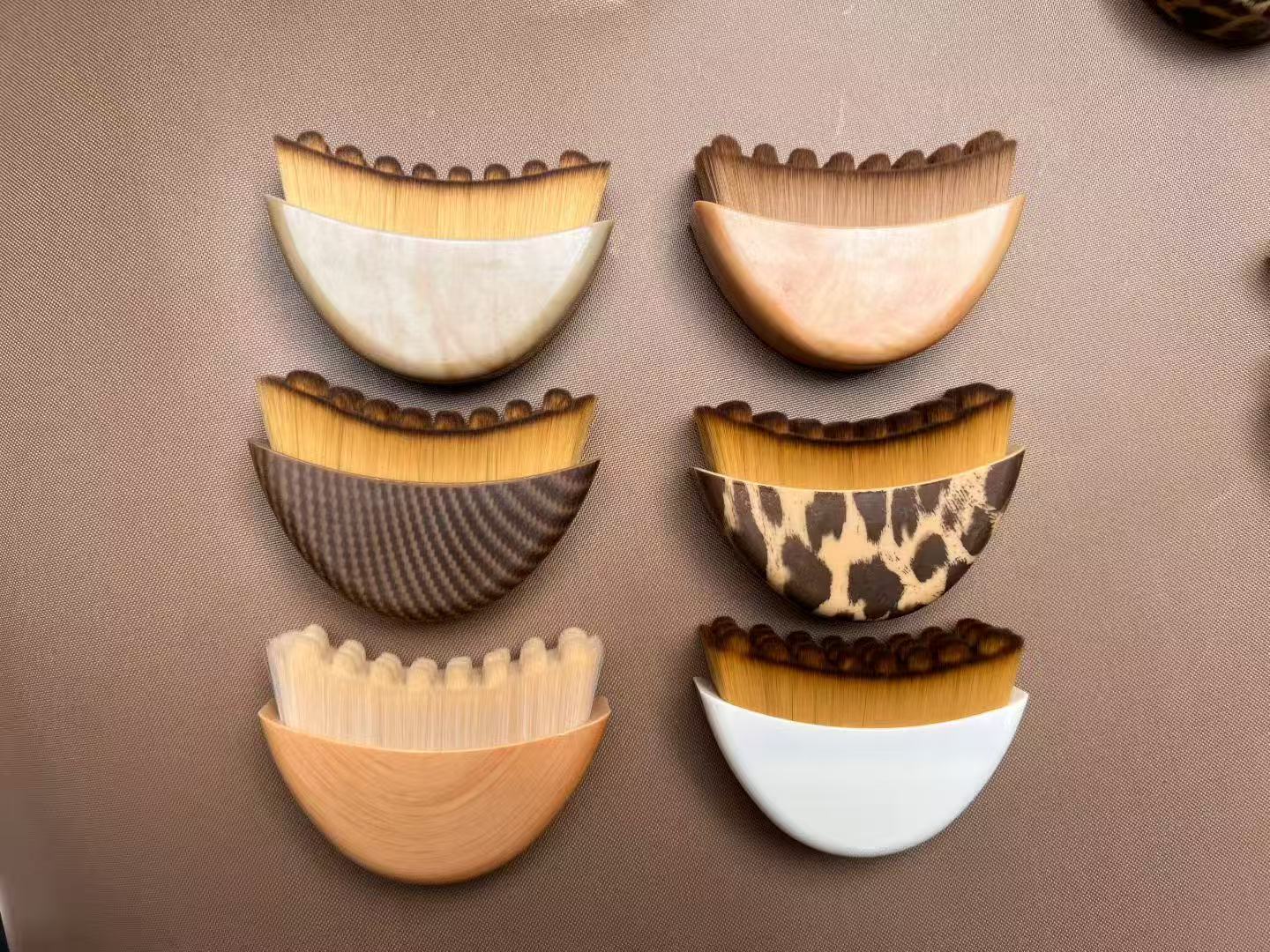 Six novelty makeup brushes with patterned handles.