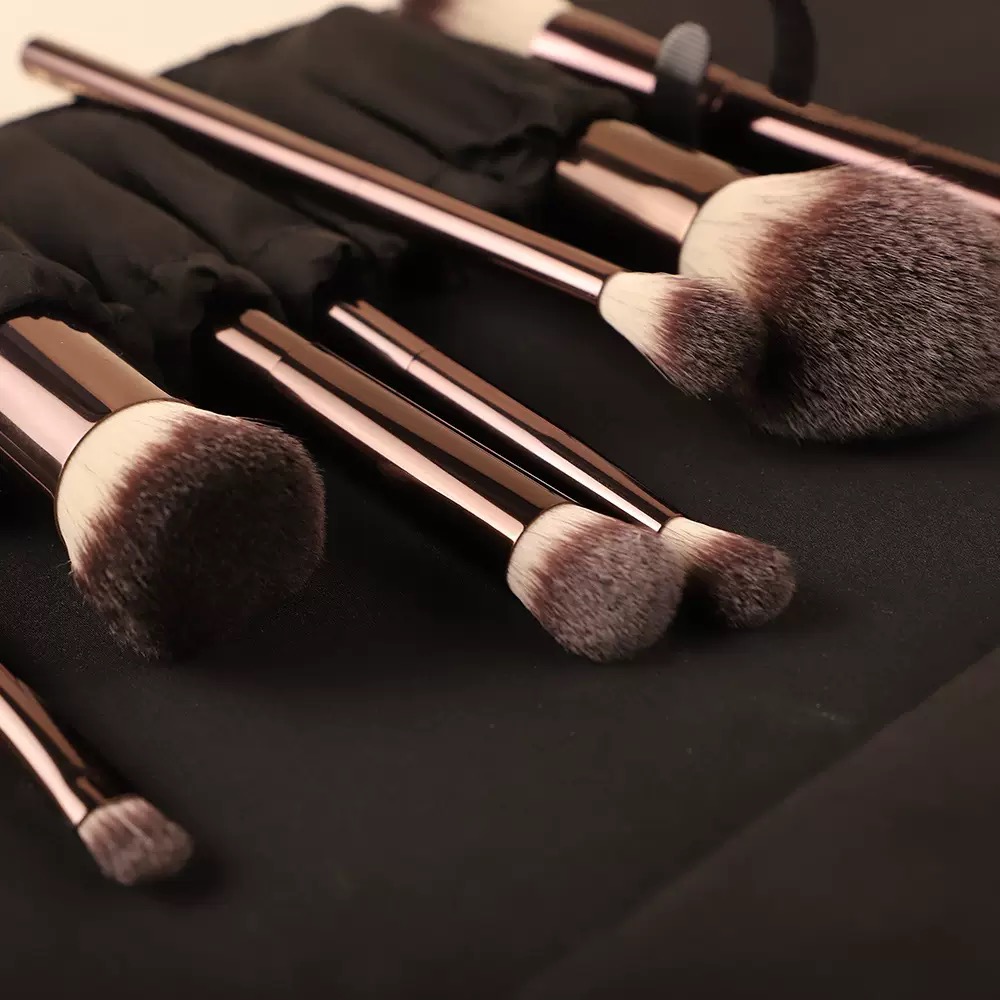 Makeup brushes with rose gold handles in a black case