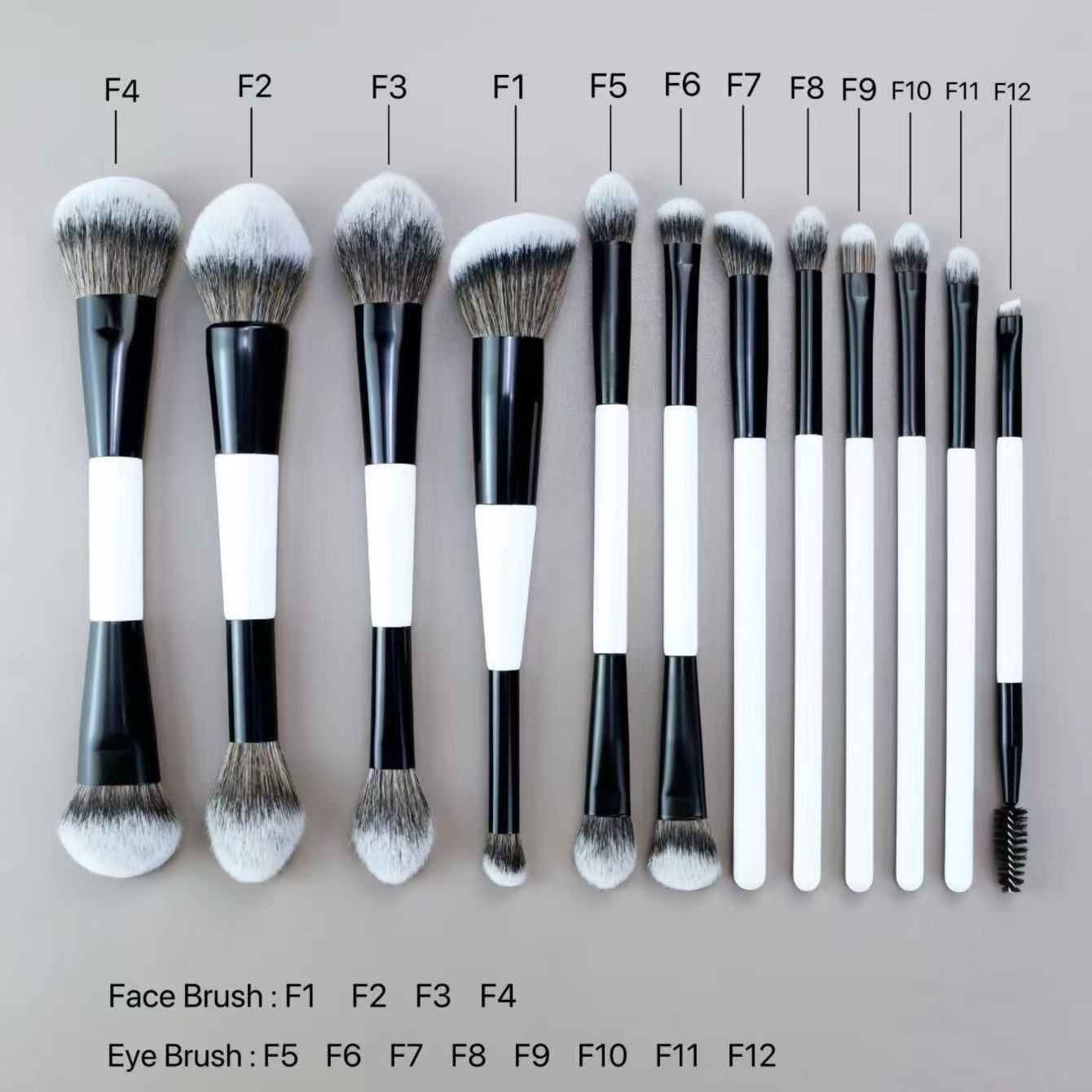 Makeup brush set with black and white handles, including face and eye brushes.