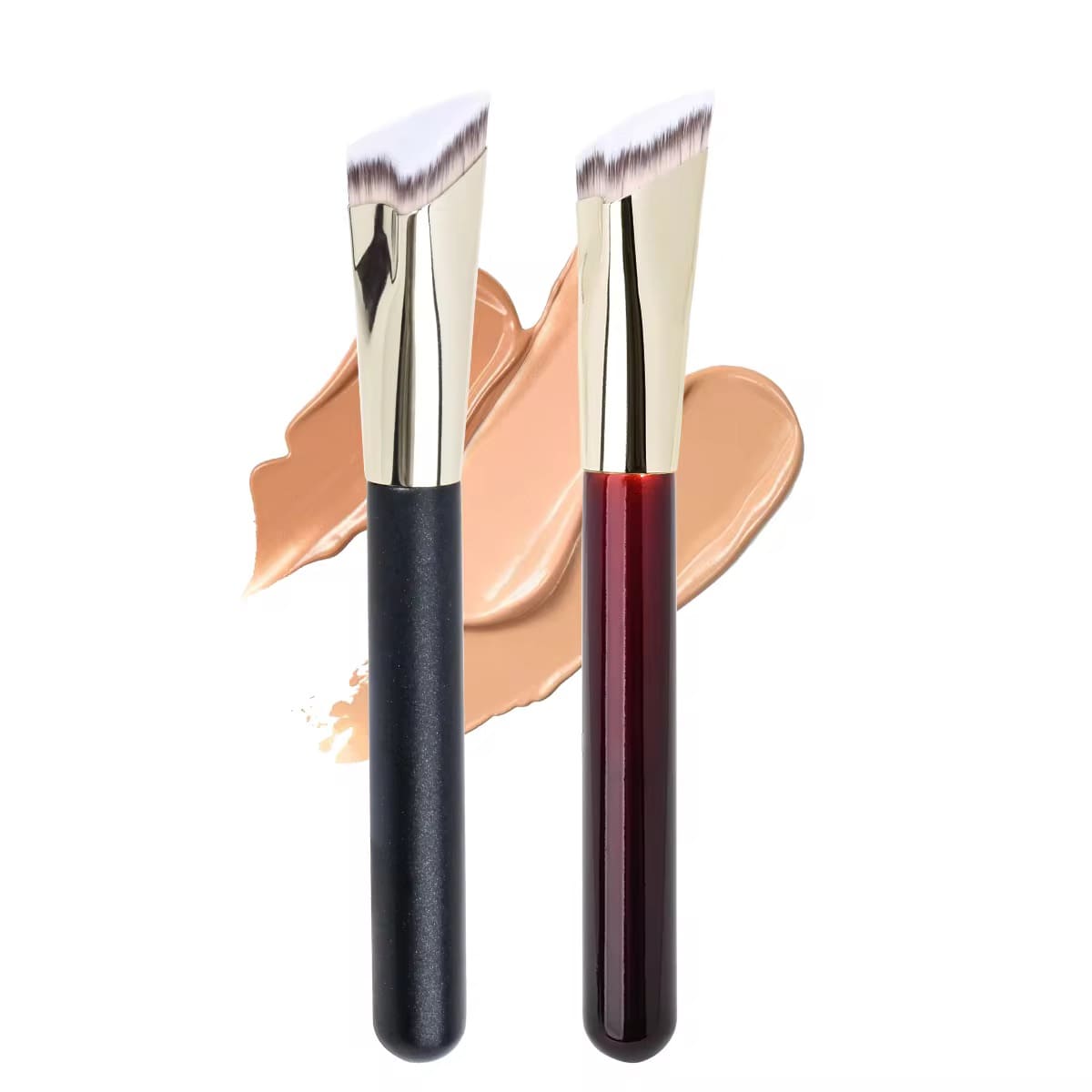 Two angled foundation brushes, one black and one dark red, with foundation swatches.