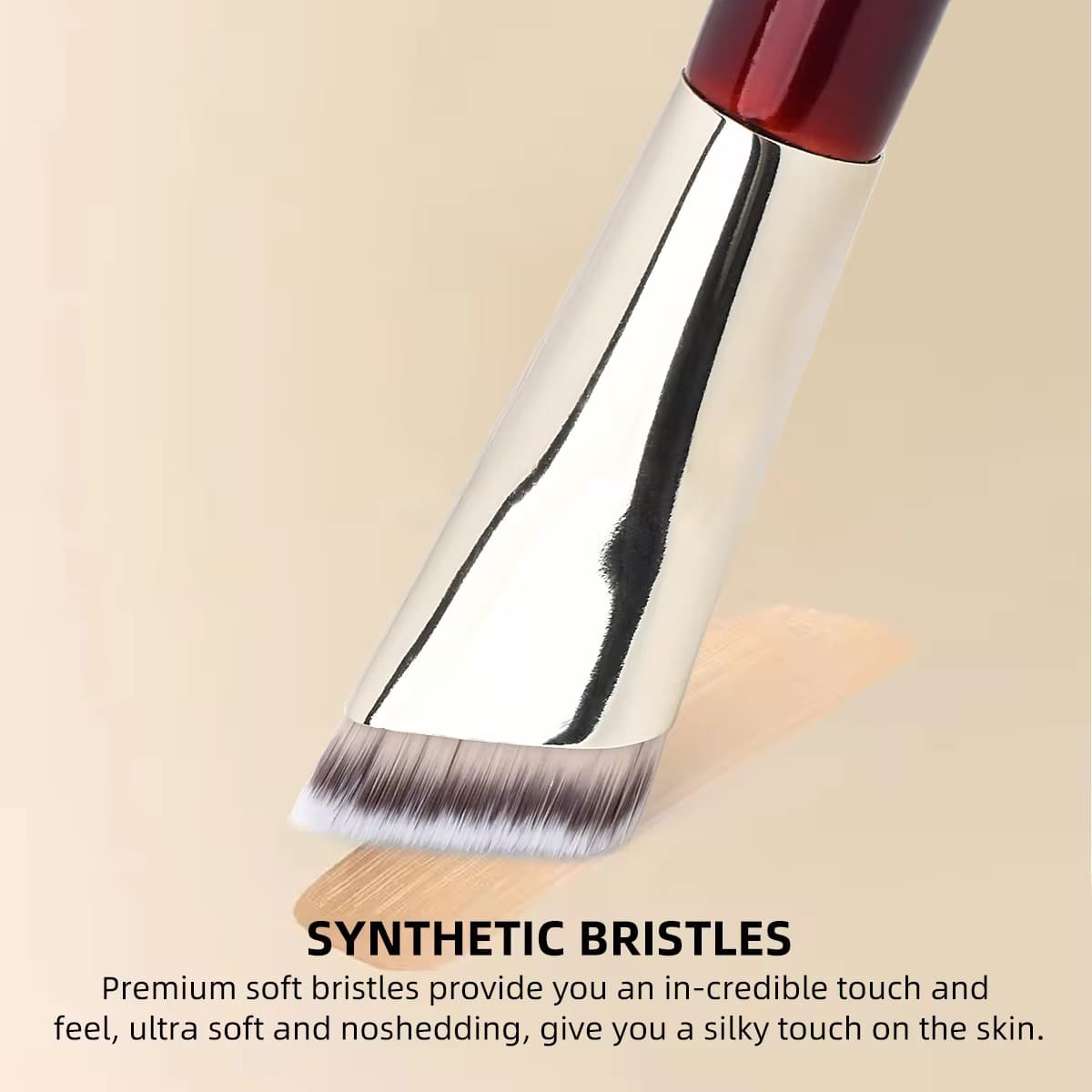 Makeup brush with synthetic bristles applying foundation.