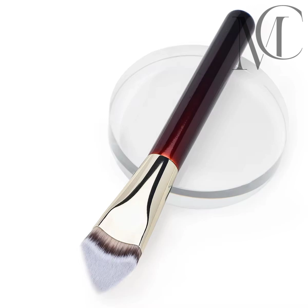 Angled Foundation Brush for sale Makeup brush with dark red handle and angled light bristles on a clear stand.